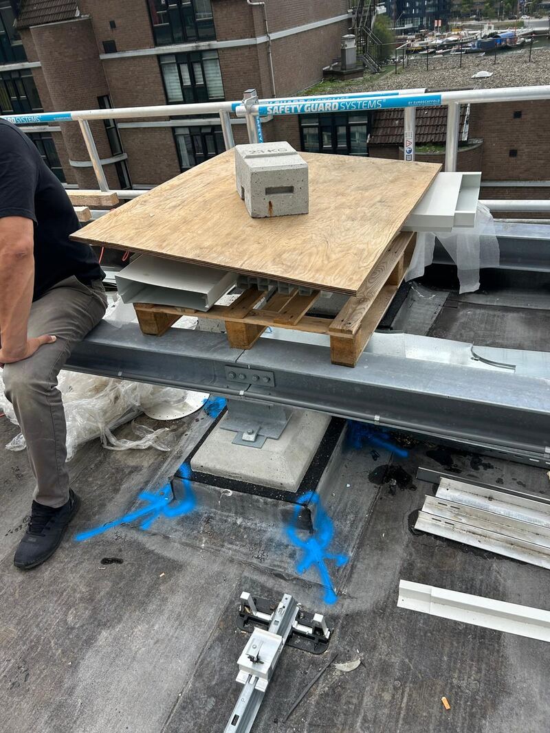 Dakdoorvoer op een plat dak met een houten plaat en stalen constructie